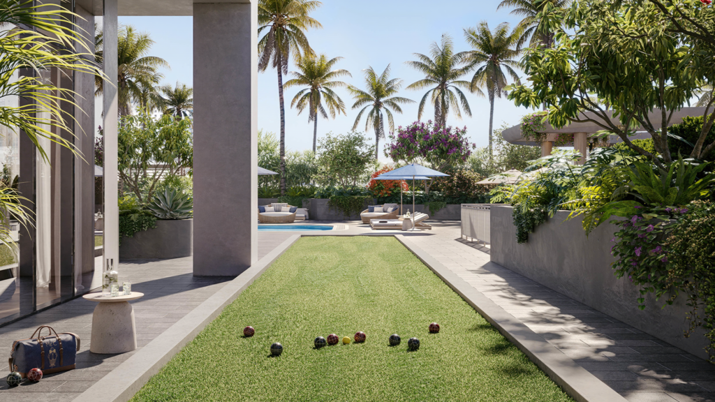 Landscaped outdoor living area at a luxury South Florida condominium with palm trees, pool and lawn.