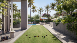 Landscaped outdoor living area at a luxury South Florida condominium with palm trees, pool and lawn.