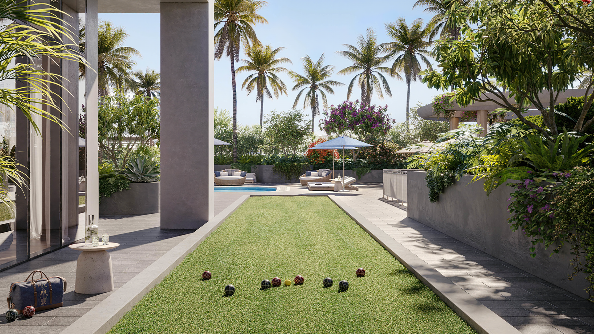 Landscaped outdoor living area at a luxury South Florida condominium with palm trees, pool and lawn.
